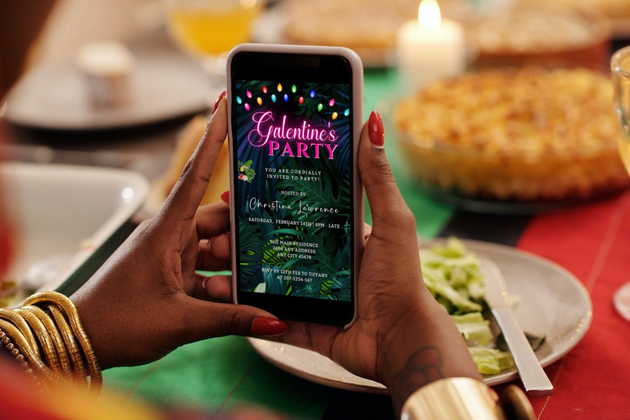 Person holding a phone displaying a Tropical Neon Pink Galentines Brunch Party Evite template, ready for customization and digital sharing.