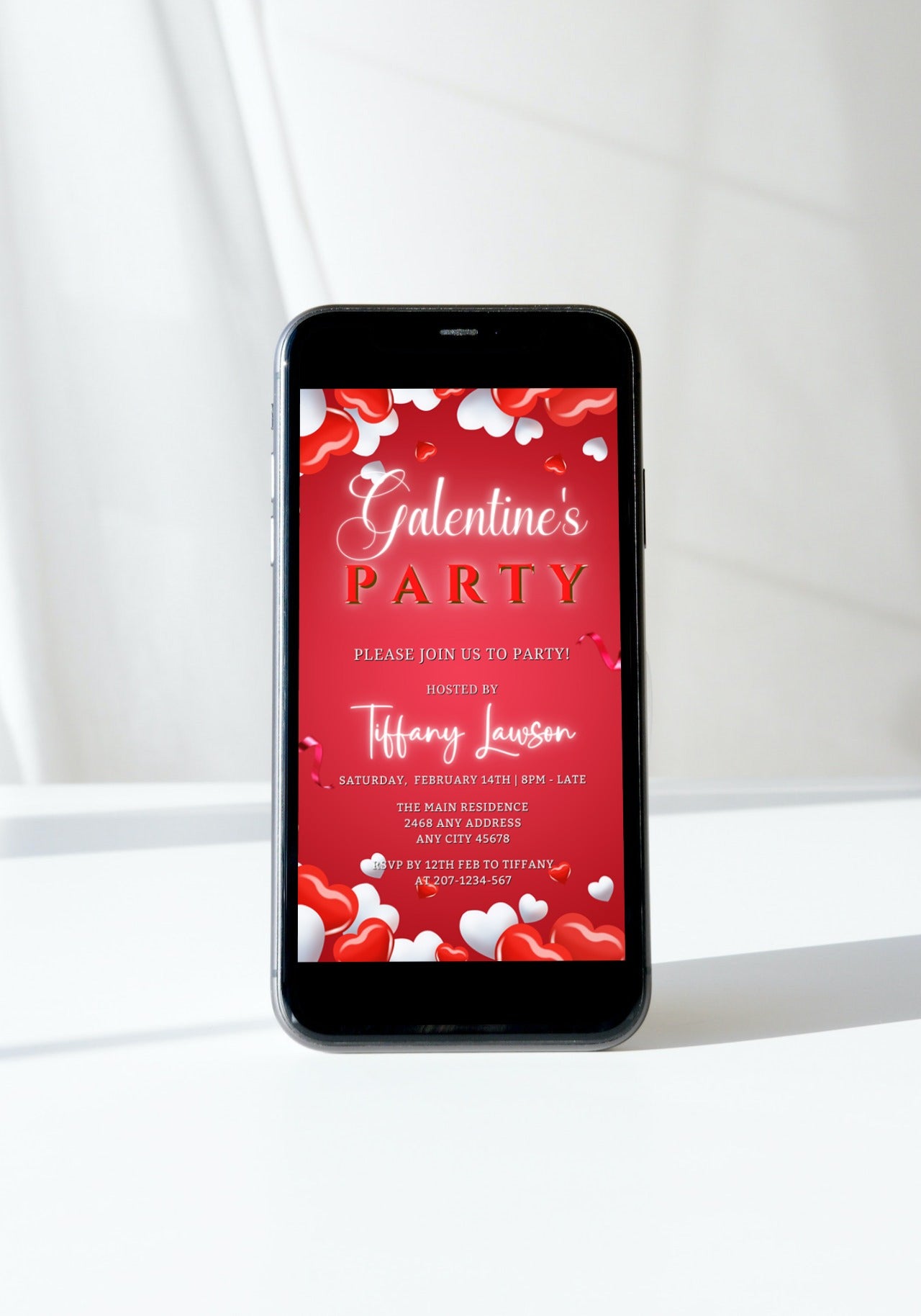 Smartphone displaying the editable Red White Boarder Hearts | Galentines Party Evite template for customisable digital invitations.