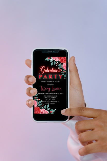 Hand holding a smartphone displaying the Red Teal Floral Rose Galentines Party Evite, a customizable digital invitation template from URCordiallyInvited.