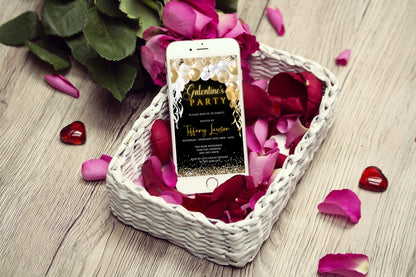 Gold White Balloons Glitter Galentines Party Evite displayed in a basket of rose petals, showcasing a customizable digital invitation for smartphones.