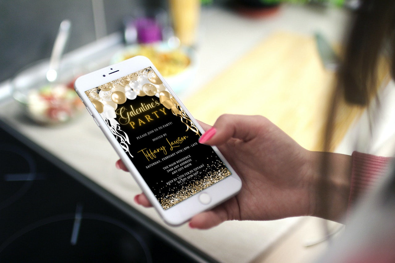 Hand holding a smartphone displaying a Gold White Balloons Glitter Galentines Party Evite, editable via Canva for easy event personalization and digital sharing.