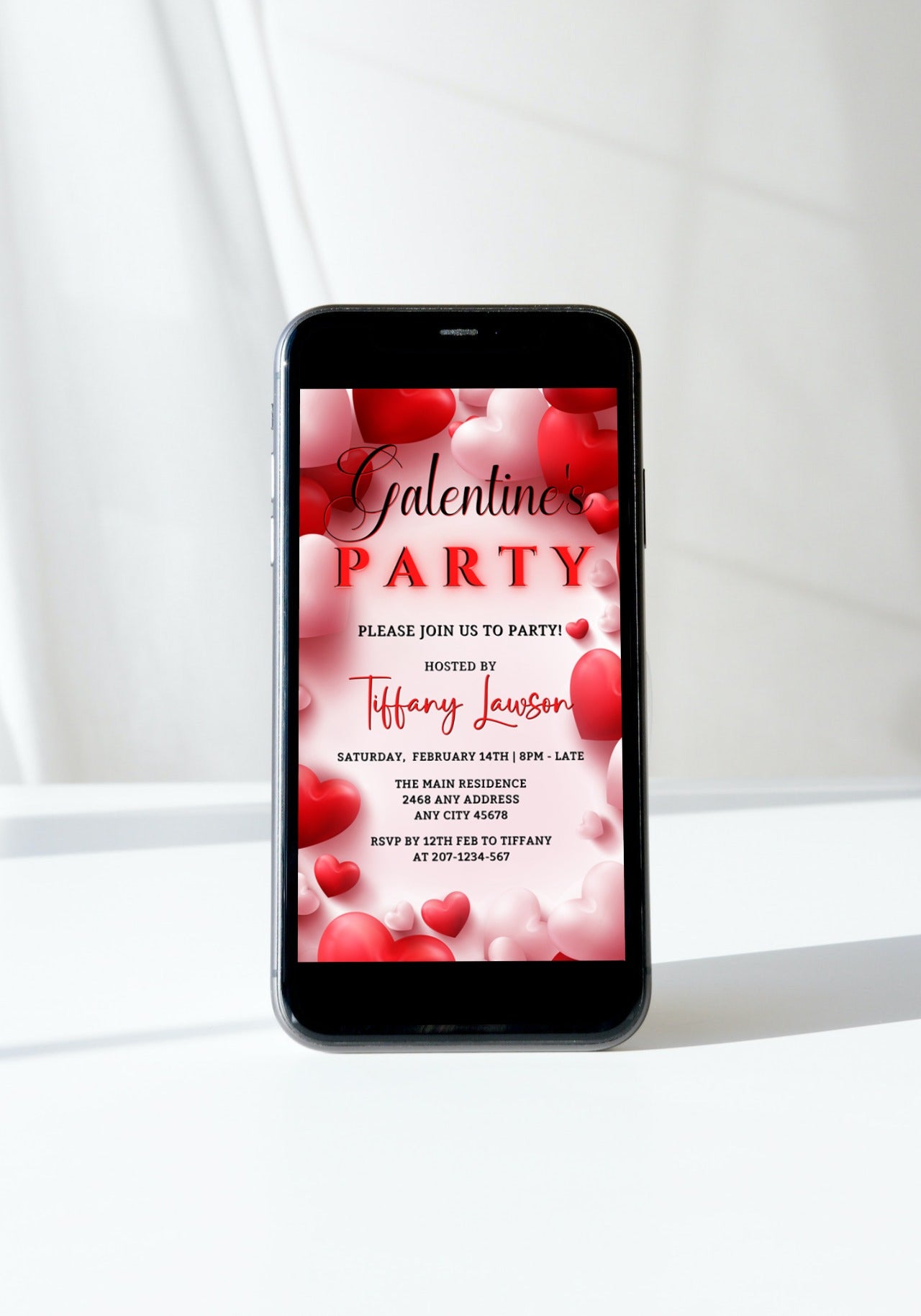 Digital invitation displayed on a smartphone screen, featuring customizable red hearts design for a Galentine's party. Editable via Canva for easy event personalization.