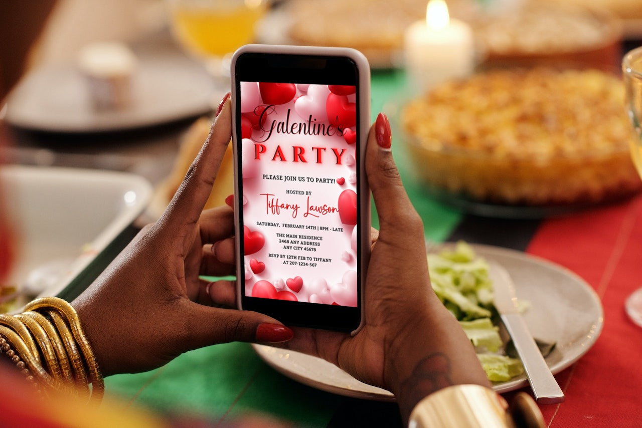 Person holding a smartphone displaying a customizable digital invitation template for a Galentines Party from URCordiallyInvited.
