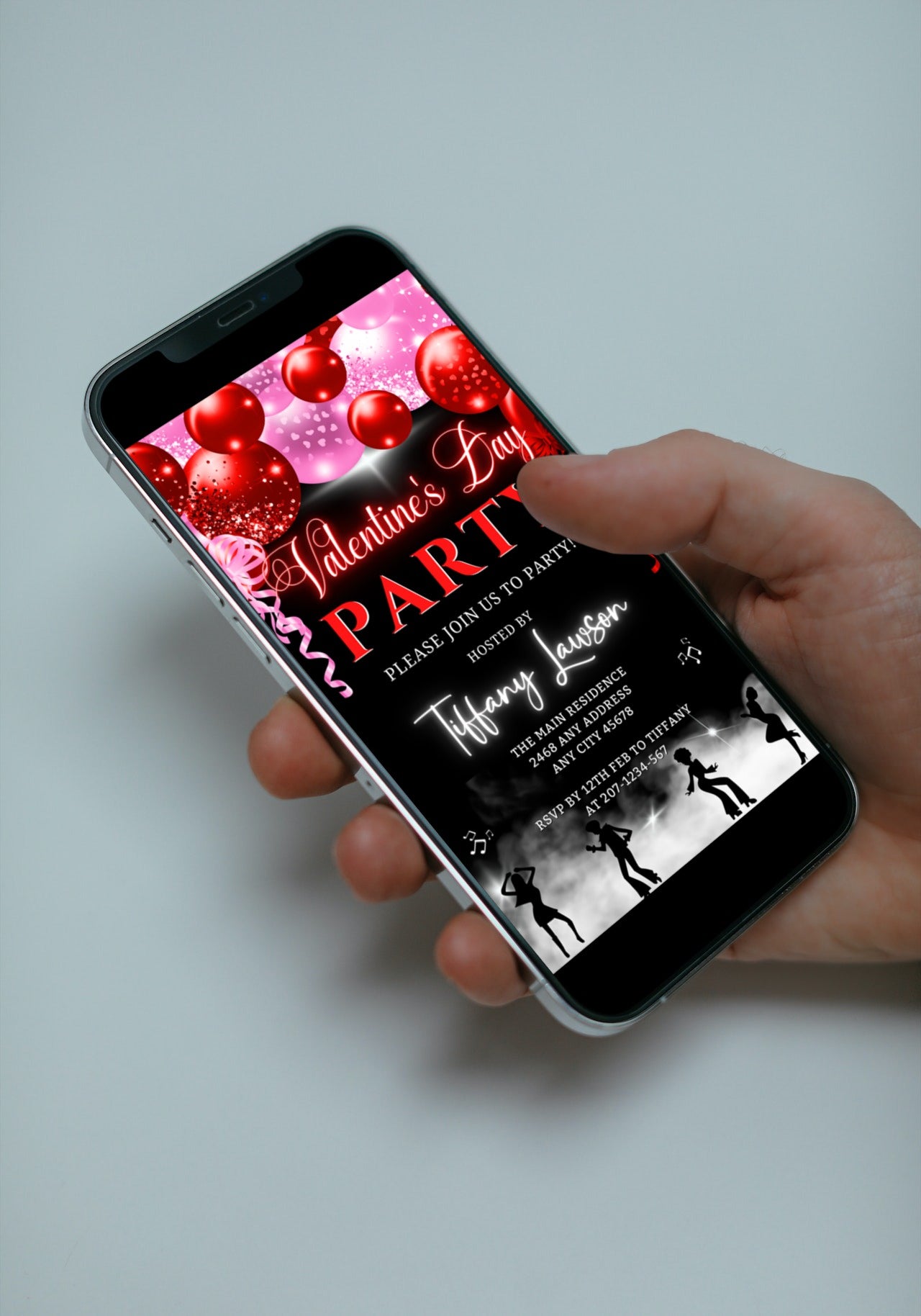 Hand holding a smartphone displaying the Neon Red Pink Smoking Dancers Valentines Party Evite, customizable via Canva for digital invitations.