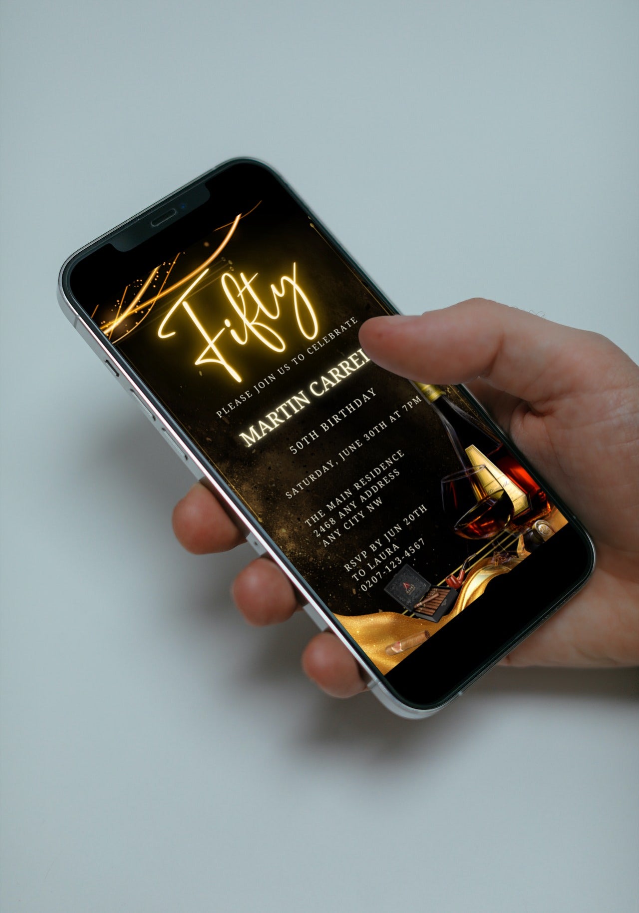 Hand holding a smartphone displaying a Men's Gold Neon Cigar 50th Birthday Evite template, ready for customization via Canva.