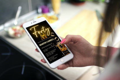 Hand holding a phone displaying the customisable Black Gold Neon Cube Splash | 40AF Birthday Evite template from URCordiallyInvited.
