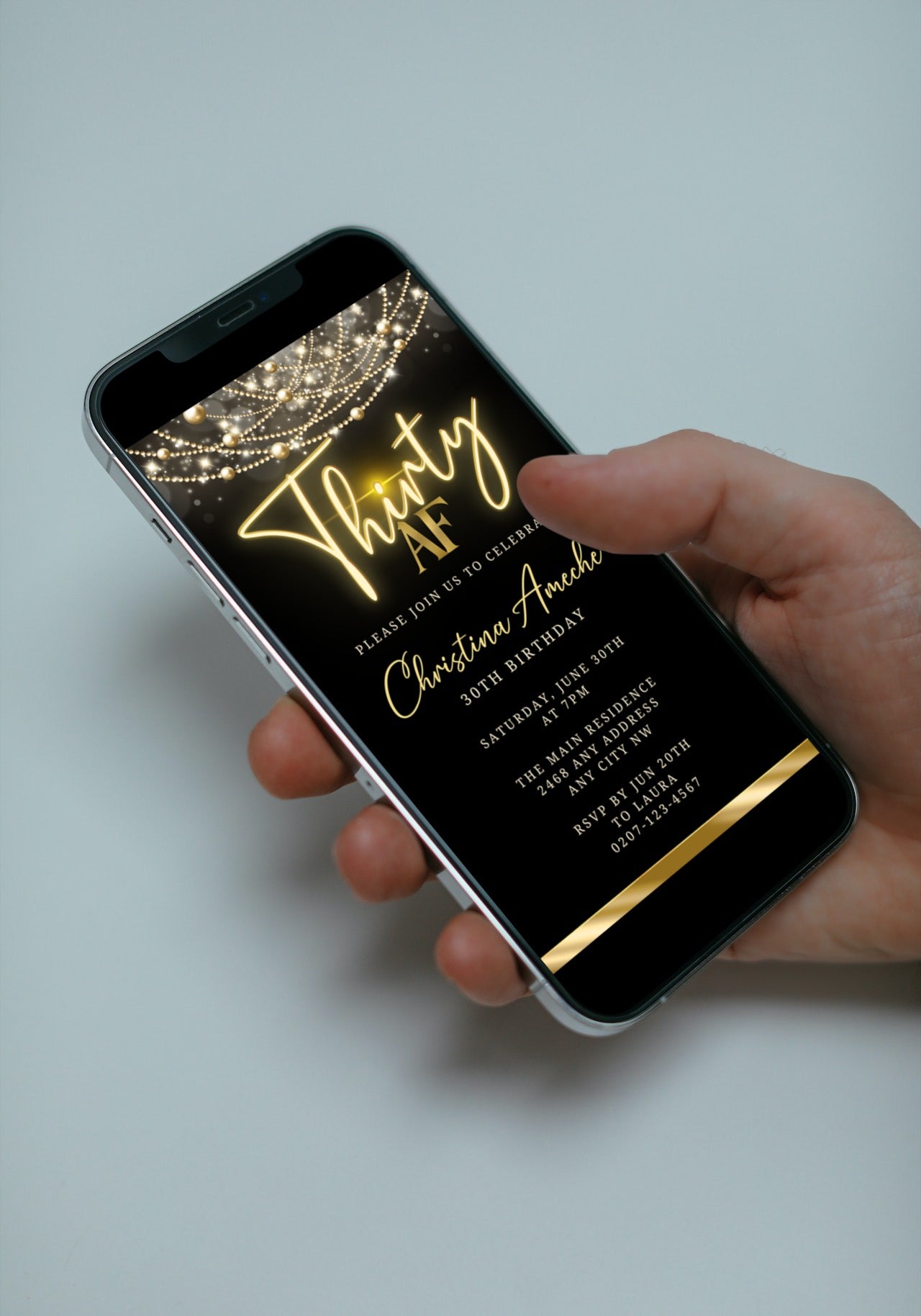 Hand holding a smartphone displaying a customizable Black Gold Neon Art Deco Bling | 30AF Birthday Evite.