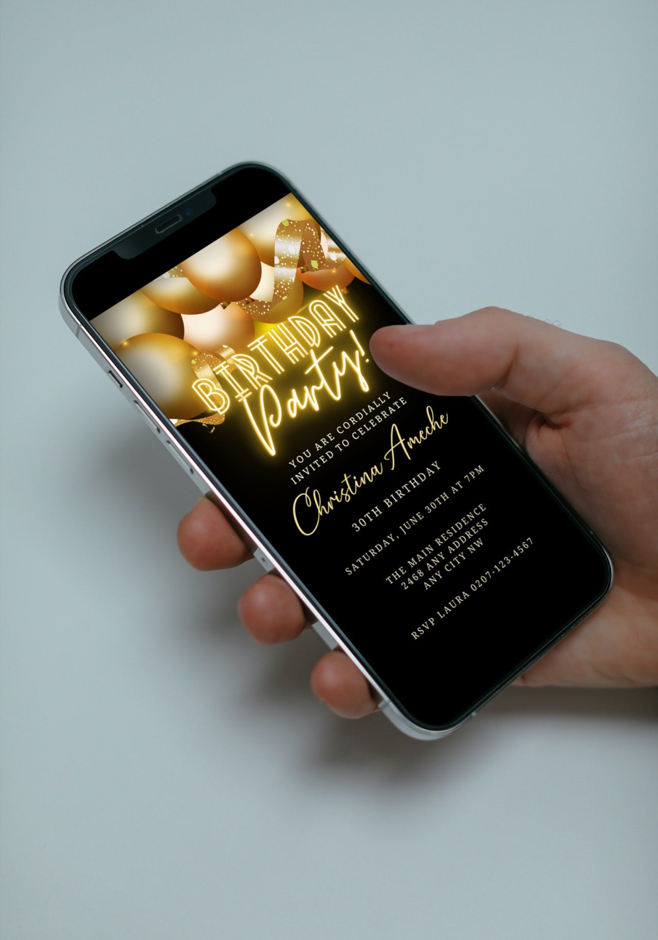 Hand holding a smartphone showcasing a Gold Neon Balloons Birthday Party Evite, customizable via Canva for easy event detail personalization and digital sharing.