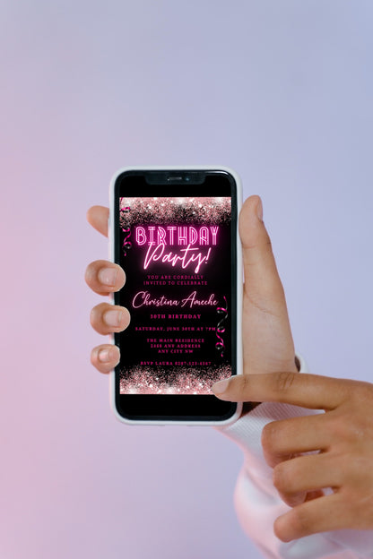 Hand holding a smartphone displaying a customizable digital neon pink glitter birthday party evite template from URCordiallyInvited.