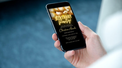 Hand holding a smartphone displaying customizable Gold Neon Balloons Birthday Party Evite, editable via Canva for instant download and easy event personalization.