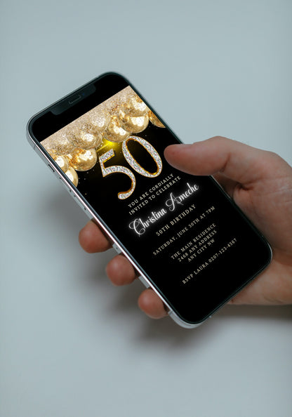 Hand holding a smartphone displaying a customizable Black Gold Balloons Glitter | 50th Birthday Evite for digital invitations via text or email.