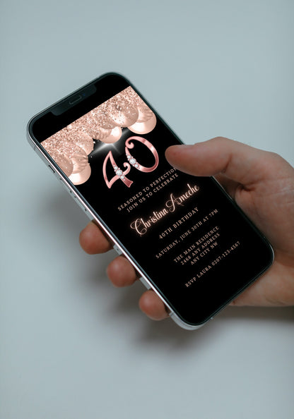 Hand holding a smartphone displaying a customizable 40th Birthday Evite with rose gold balloons and diamond studs from URCordiallyInvited.