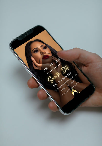 Hand holding a cell phone displaying a woman's face, showcasing the Editable Digital Birthday Photo | Save The Date Evite for customization via Canva.