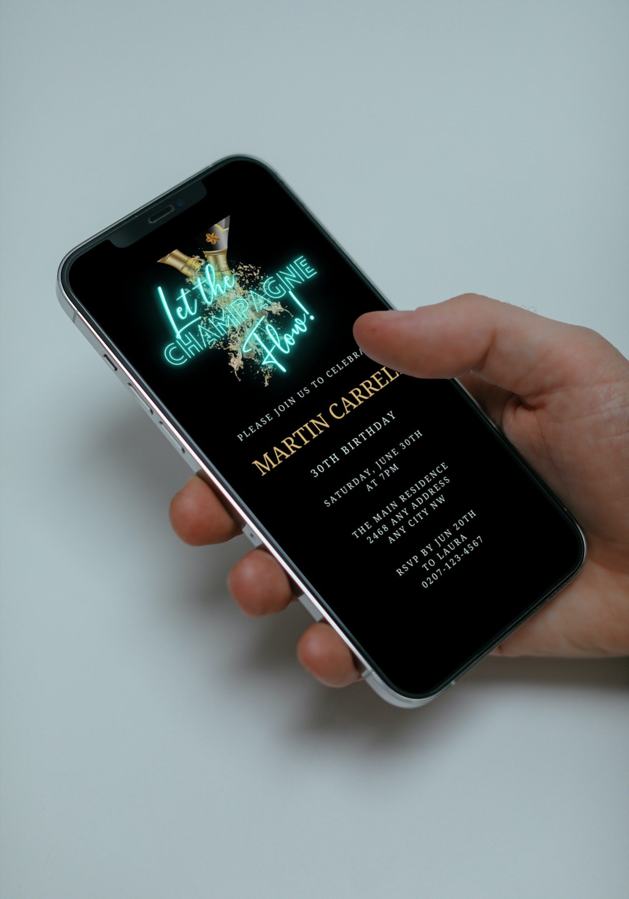 A hand holding a smartphone displaying a customizable Teal Black Champagne Birthday Party Evite from URCordiallyInvited.