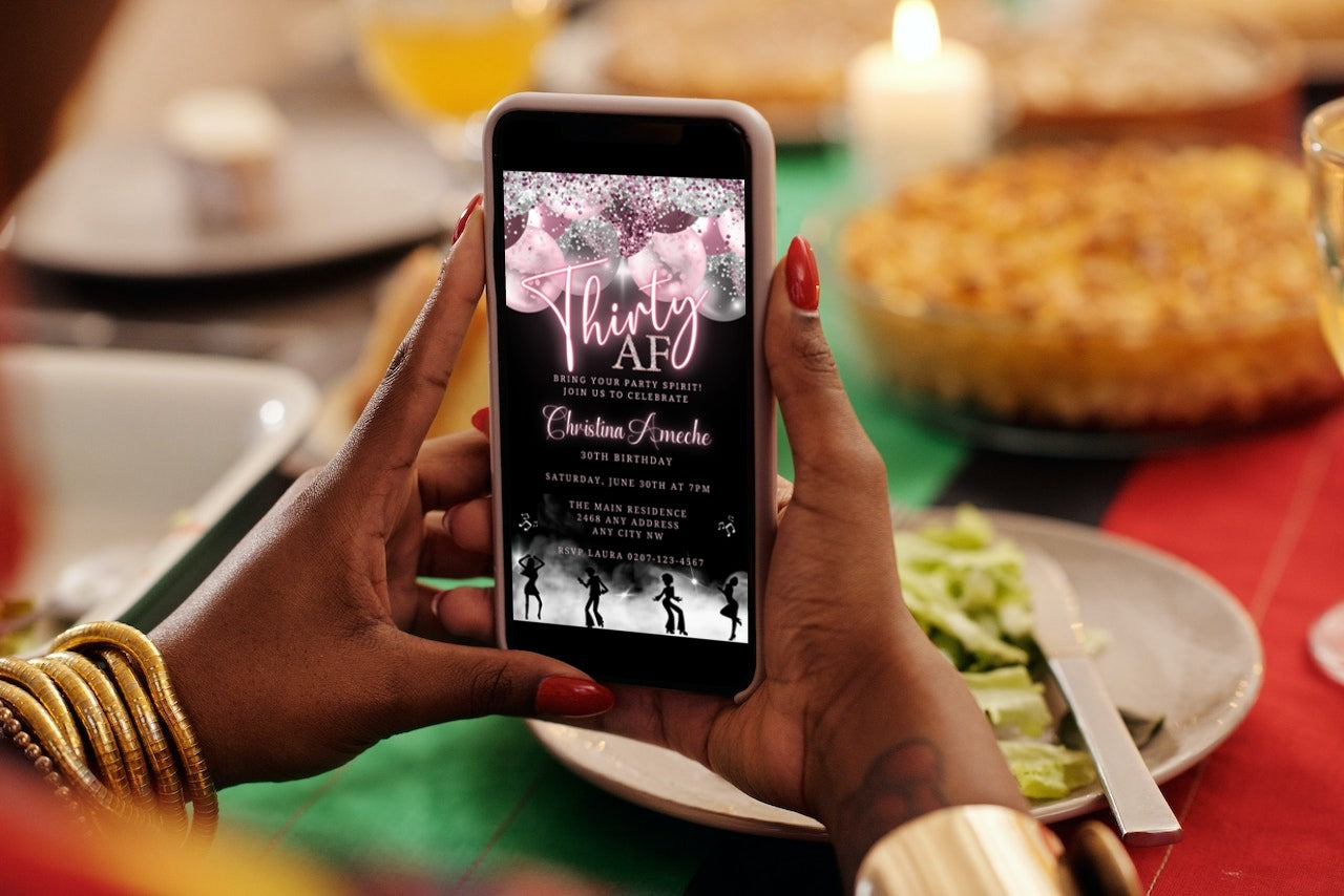 Person holding a smartphone displaying a Mauve Pink Silver Neon 30AF Birthday Video Evite template from URCordiallyInvited, ready to be customized and shared digitally.