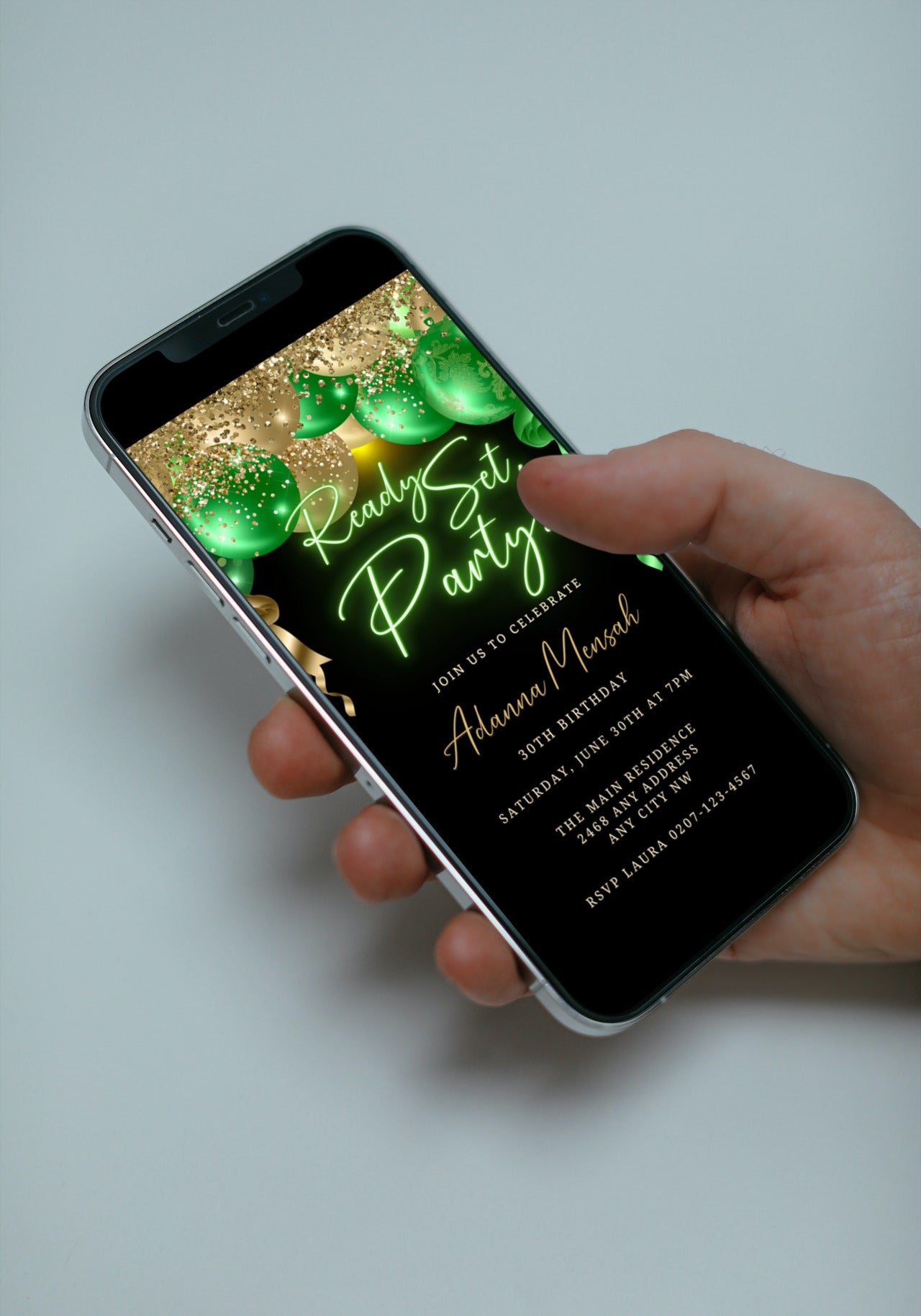 Hand holding a smartphone displaying a customizable Gold Green Neon Balloons Birthday Party Evite from URCordiallyInvited.