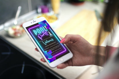 A hand holding a smartphone displaying a customizable Neon Pool Party digital invitation template for easy event personalization and electronic sharing.