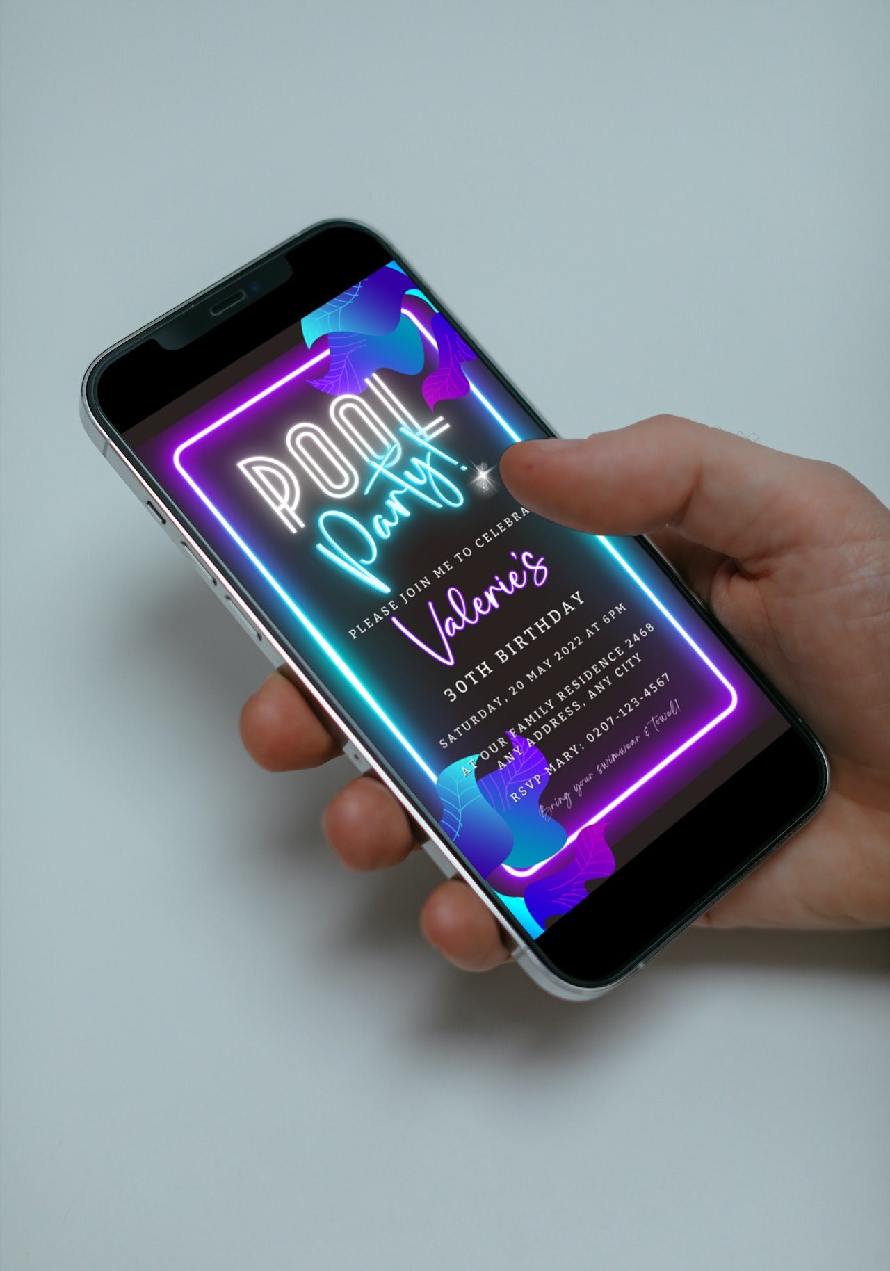 Hand holding a smartphone displaying a customizable Neon Pool Party digital invite template for editing and sharing via text, email, or messenger apps.