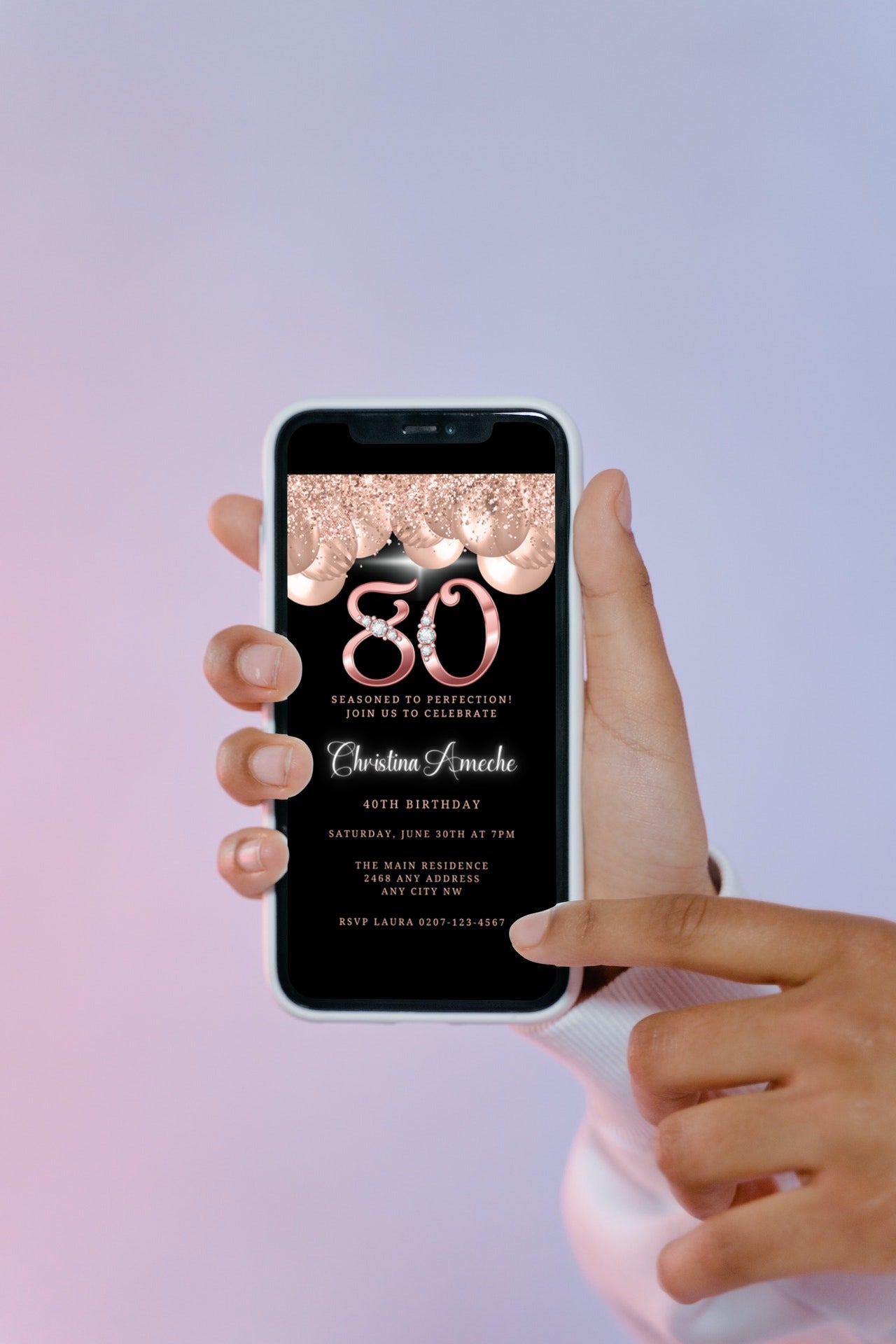 Hand holding a smartphone displaying a customisable Rose Gold Balloons Diamond Studs | 80th Birthday Evite template from URCordiallyInvited.