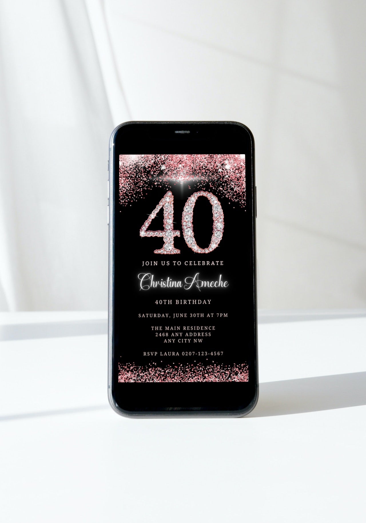 A customizable 40th birthday evite with a rose gold glitter and diamond design displayed on a smartphone screen.