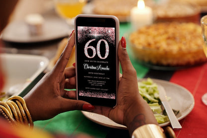 Person holding a smartphone displaying a customizable digital Rose Gold Diamond Glitter 60th Birthday Evite from URCordiallyInvited.