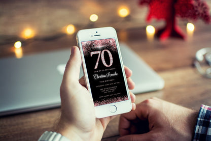 Person holding a smartphone displaying a customizable Rose Gold Diamond Glitter 70th Birthday Evite from URCordiallyInvited.