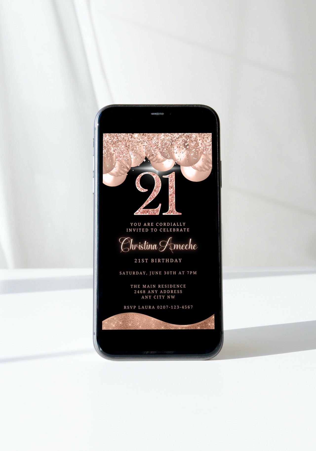 Cell phone displaying Rose Gold Balloons Glitter 21st Birthday Evite template with customizable text for digital invitations.