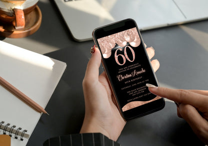 Person holding a phone displaying a customizable Rose Gold Balloons Glitter 60th Birthday Evite for editing and sharing via smartphone.