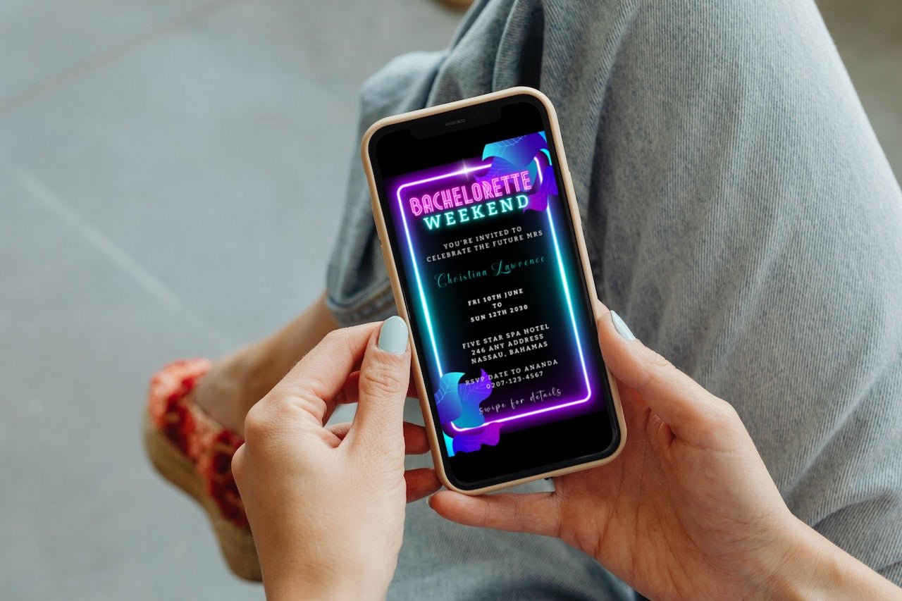 Person holding a smartphone displaying a customizable digital Neon Pink Aqua Black Bachelorette Weekend Evite template from URCordiallyInvited, ready to edit and share.