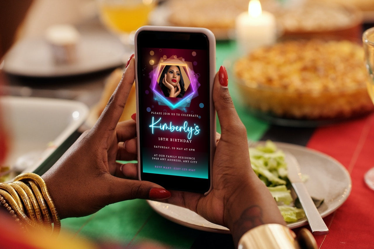 Person holding a smartphone displaying a customizable digital neon maroon teal birthday party evite with a photo of a woman.