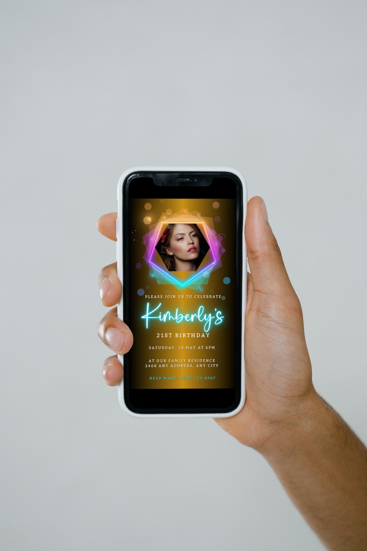 Hand holding a smartphone displaying a customizable digital birthday party evite with a woman's photo, offered by URCordiallyInvited for easy personalization via Canva.