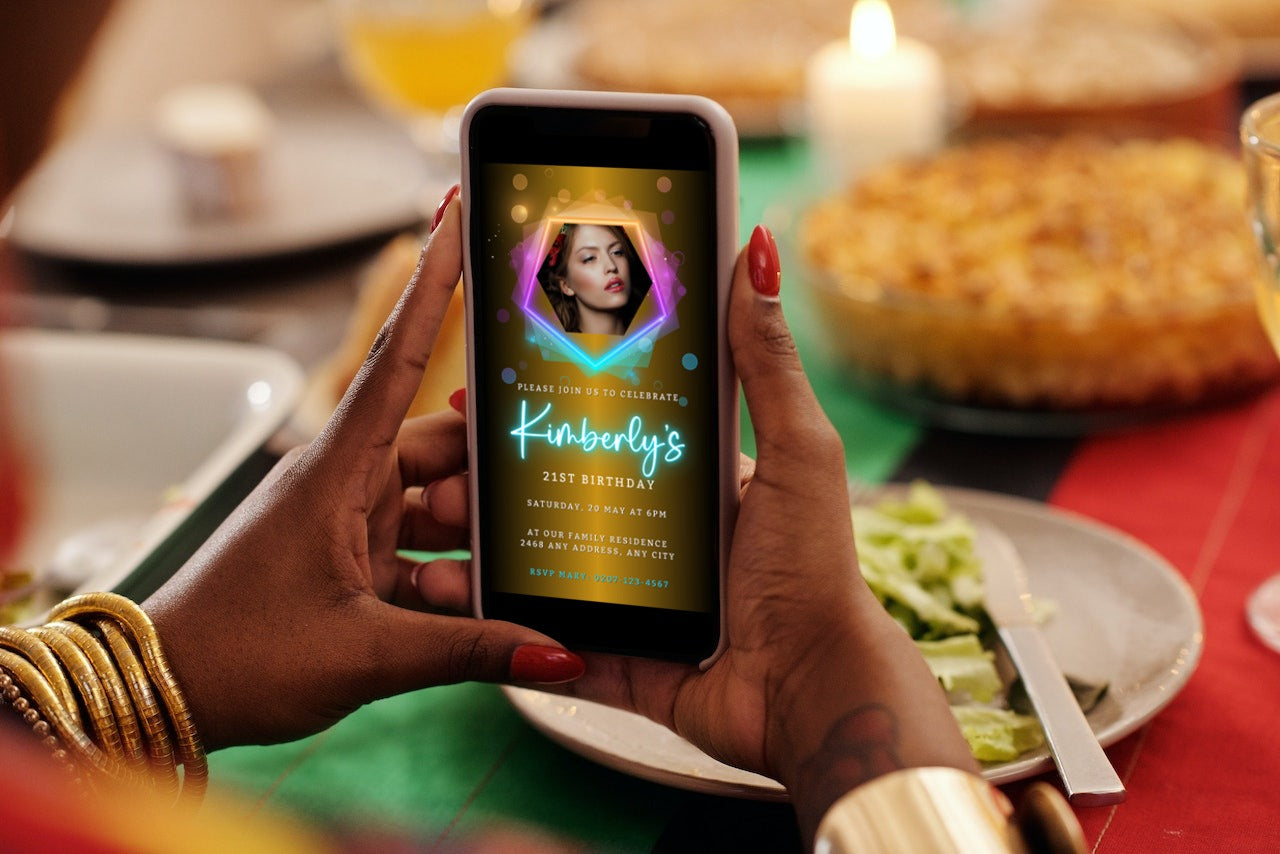 Person holding a smartphone displaying a customizable Gold Pink Teal Neon Birthday Party Evite template with a woman's photo.