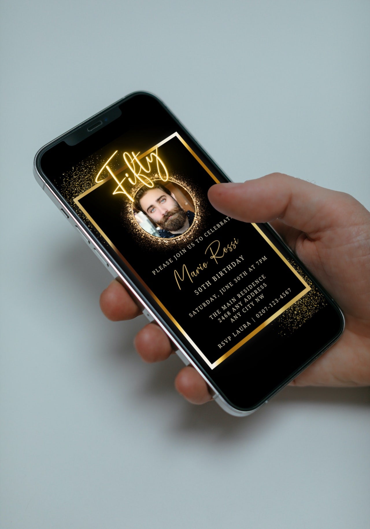 Hand holding a smartphone displaying a customizable Neon Gold Oval Photo Frame | 50th Birthday Evite, editable via Canva for digital invitations.