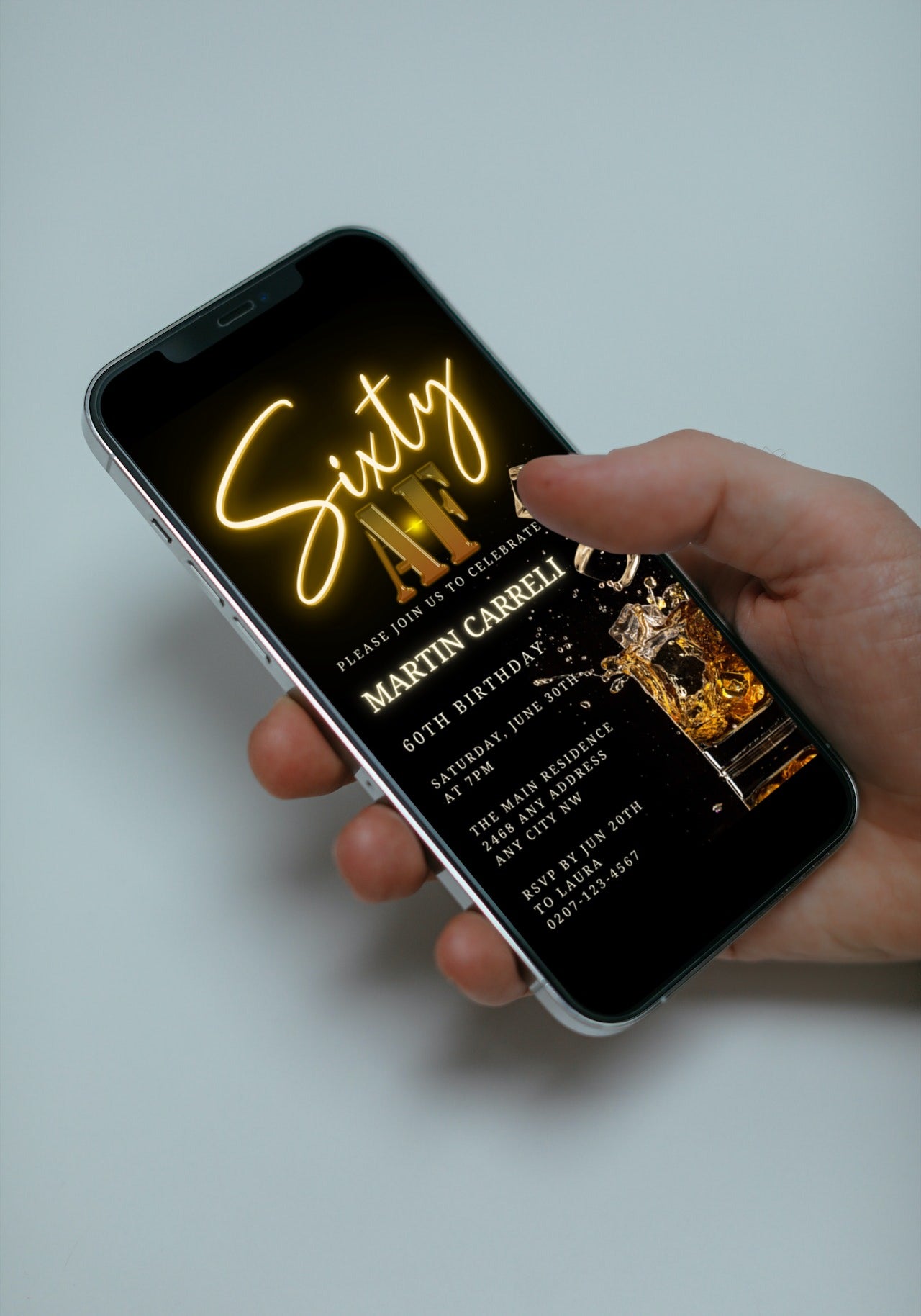 Hand holding a smartphone displaying a customizable Black Gold Neon Cube Splash | 60AF Birthday Evite template from URCordiallyInvited.