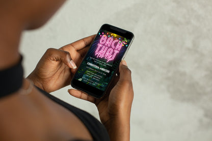 Person holding a smartphone displaying a customizable Tropical Neon Pink | Bach That Ass Up Weekend Evite template from URCordiallyInvited.