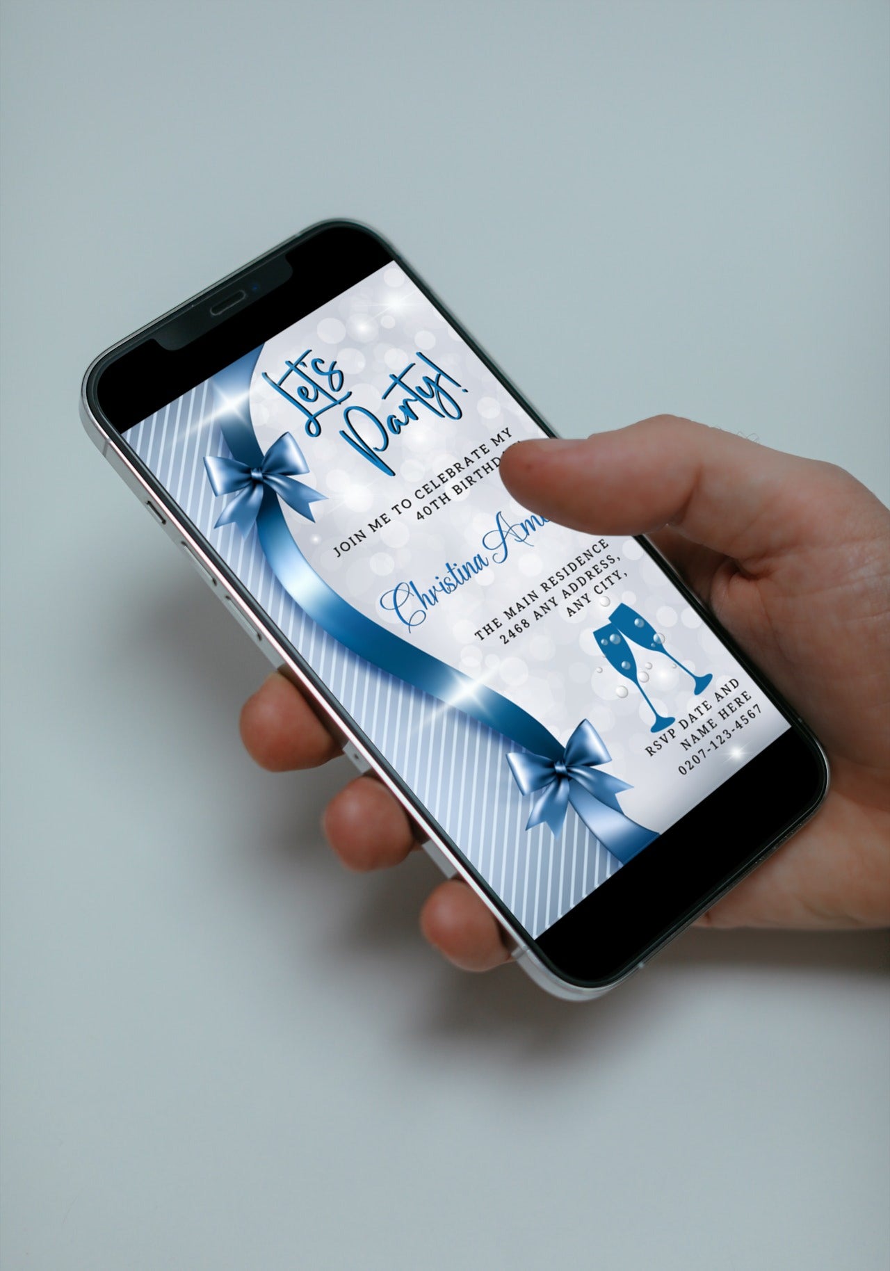 Hand holding a smartphone displaying the Blue Silver Bow Sparkle | Editable Birthday Evite template for customizable digital invitations.