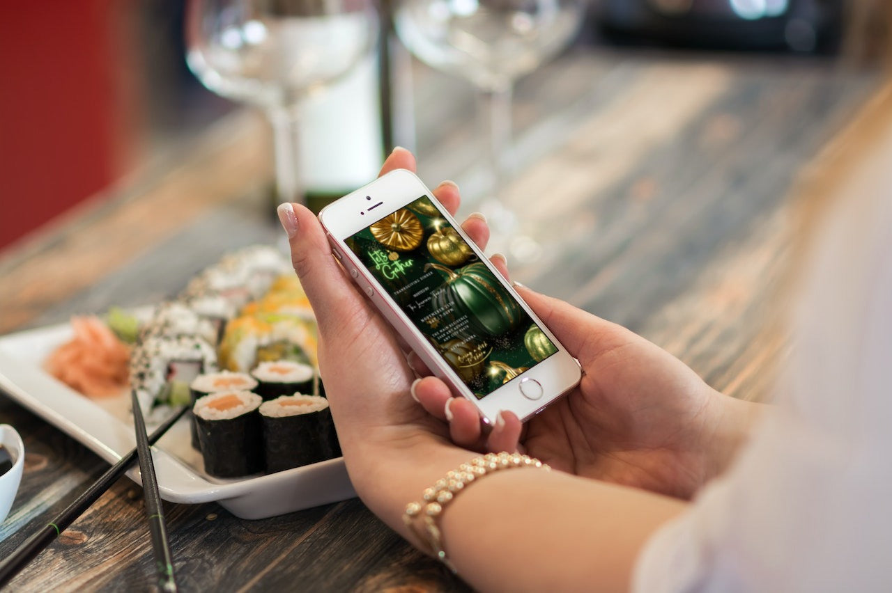 Person holding a phone displaying the Green Gold Pumpkin Glitter | Thanksgiving Dinner Video Invite template from URCordiallyInvited.