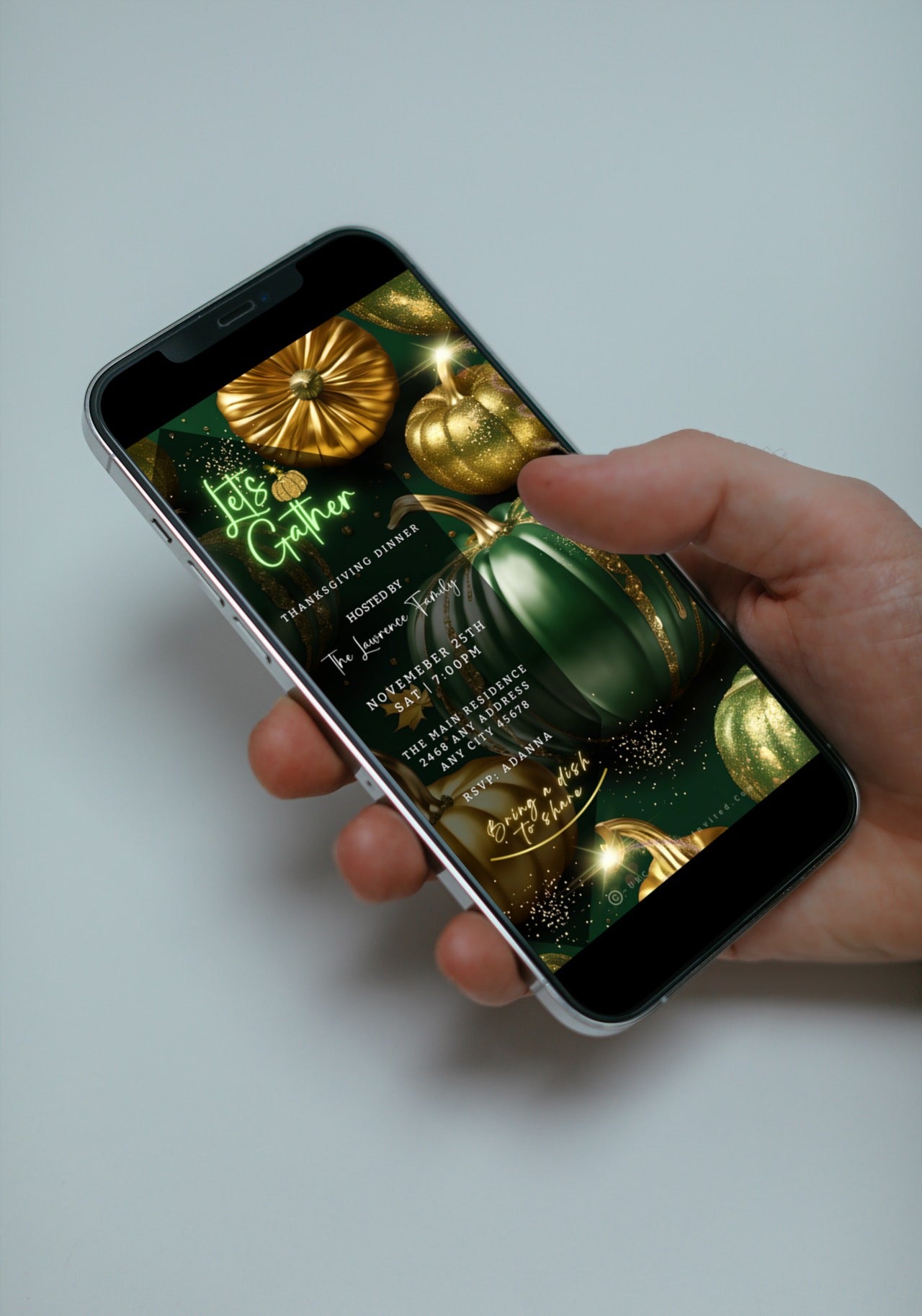 Hand holding a cell phone displaying the Green Gold Pumpkin Glitter Thanksgiving Dinner Video Invite, customizable via Canva for electronic sharing through various messaging apps.