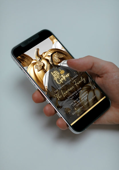 Hand holding a mobile phone displaying the Gold Neon White Pumpkin Thanksgiving Dinner Video Invite template for customization via Canva.