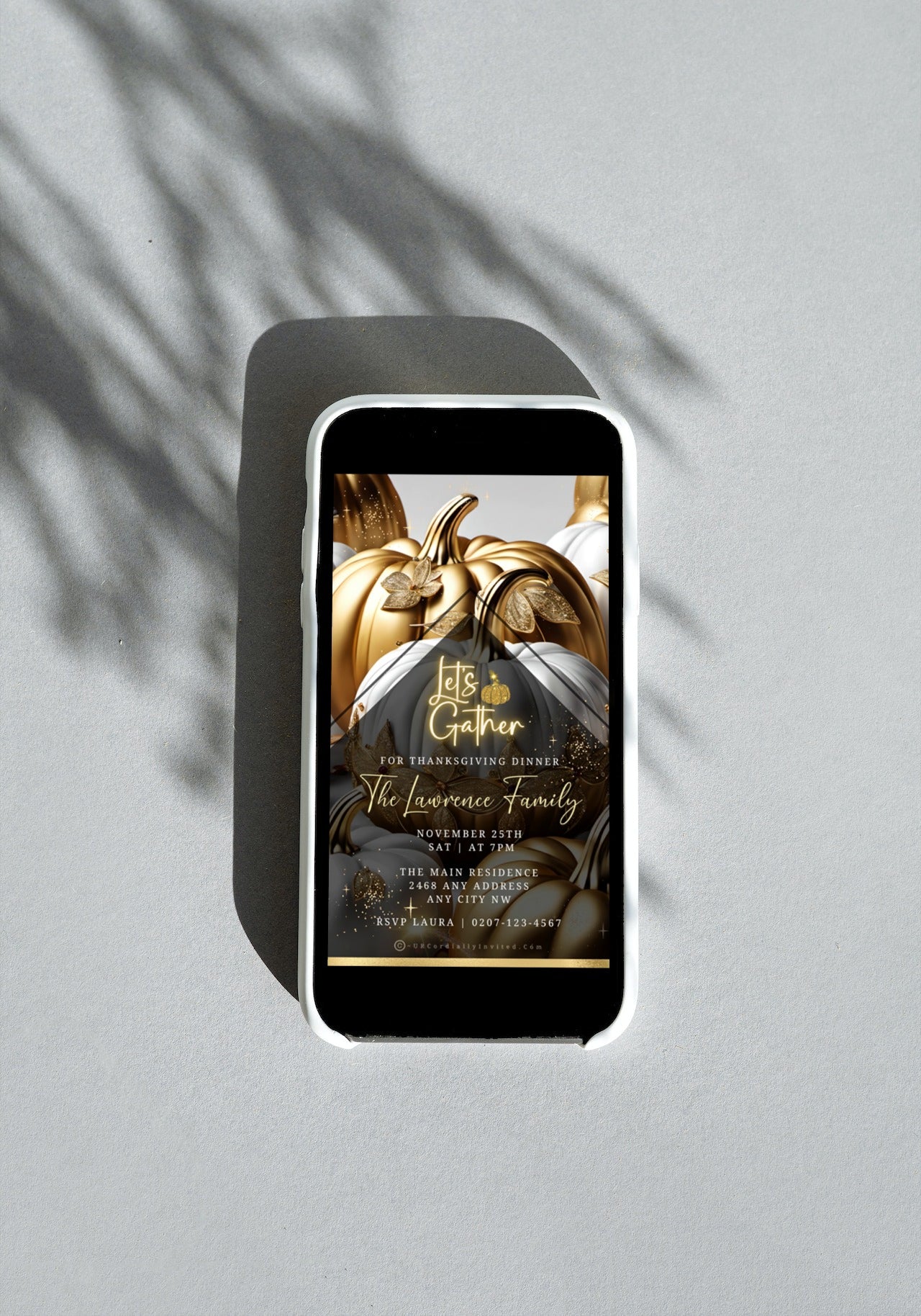 Gold Neon White Pumpkin Thanksgiving Dinner Video Invite template displayed on a cell phone with gold and white pumpkin design.