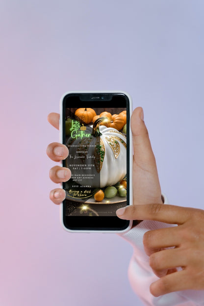 Hand holding a cell phone displaying a customizable White Fruitful Platter Glitter Pumpkin Thanksgiving Dinner Video Invite template.