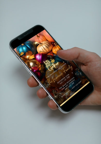 Hand holding a smartphone displaying the Multicoloured Sparkle Pumpkins | Thanksgiving Dinner Video Invite template from URCordiallyInvited.