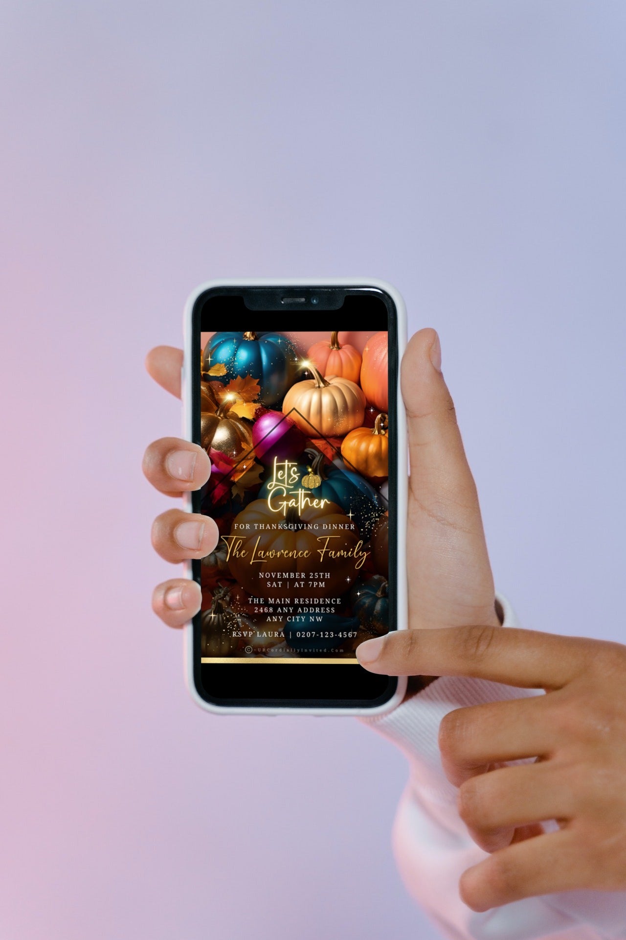 Hand holding a smartphone displaying a Multicoloured Sparkle Pumpkins Thanksgiving Dinner Video Invite template.