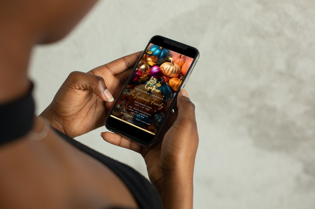 Person holding a smartphone with a Multicoloured Sparkle Pumpkins Thanksgiving Dinner Video Invite template displayed on the screen.