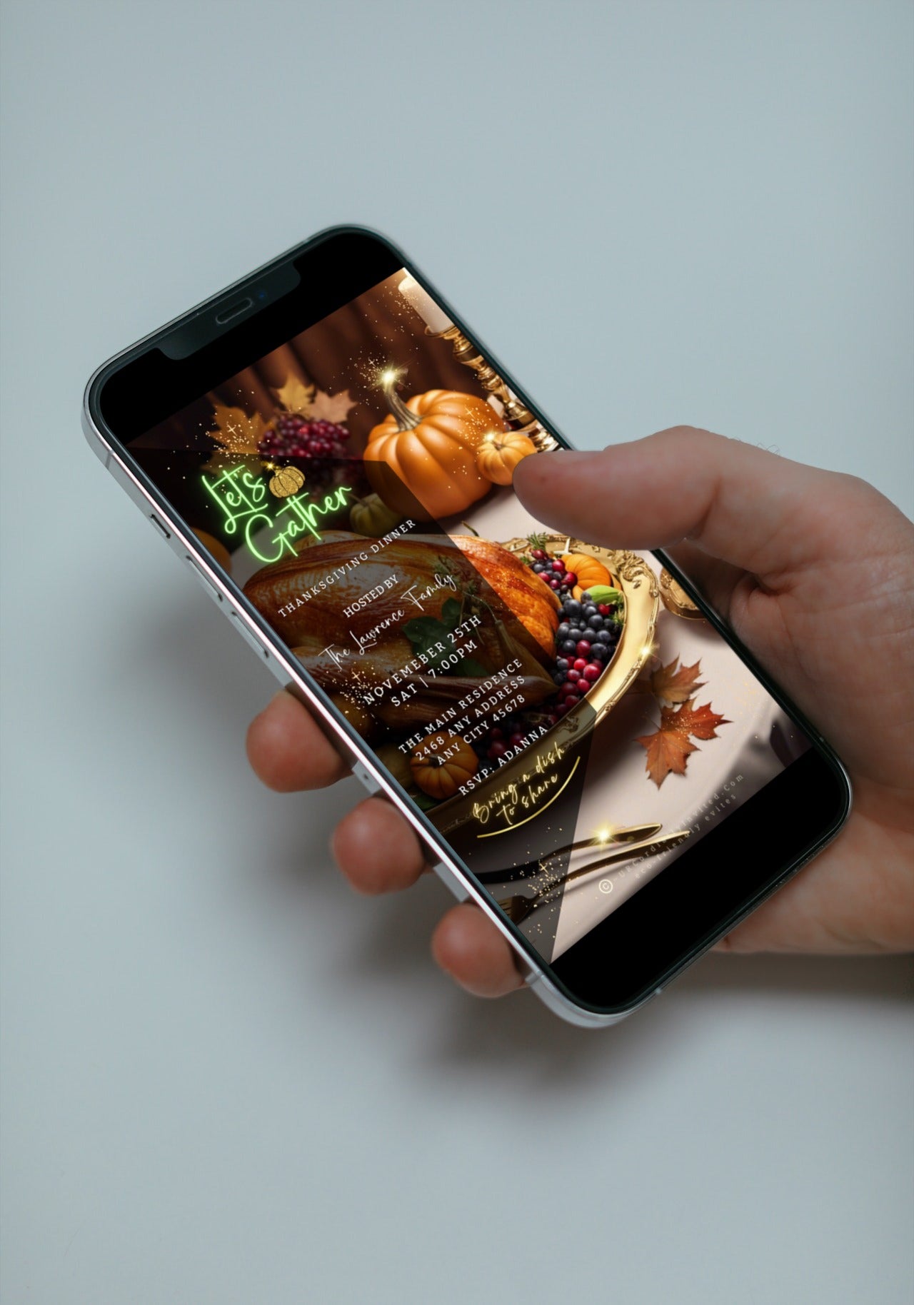 Hand holding a smartphone displaying a Gold Fruitful Platter Pumpkins | Thanksgiving Dinner Video Invite template with a picture of a turkey and fruit.