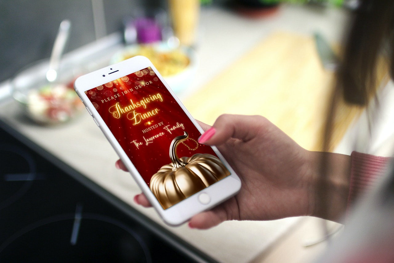 Hand holding a phone displaying a Red Gold Pumpkin Glitter Thanksgiving Dinner Video Invite, customizable via Canva for electronic sharing.