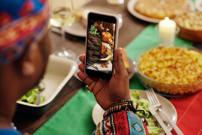 Person taking a picture of a Thanksgiving dinner on a mobile phone for Gold Fruitful Platter Pumpkins | Thanksgiving Dinner Video Invite.
