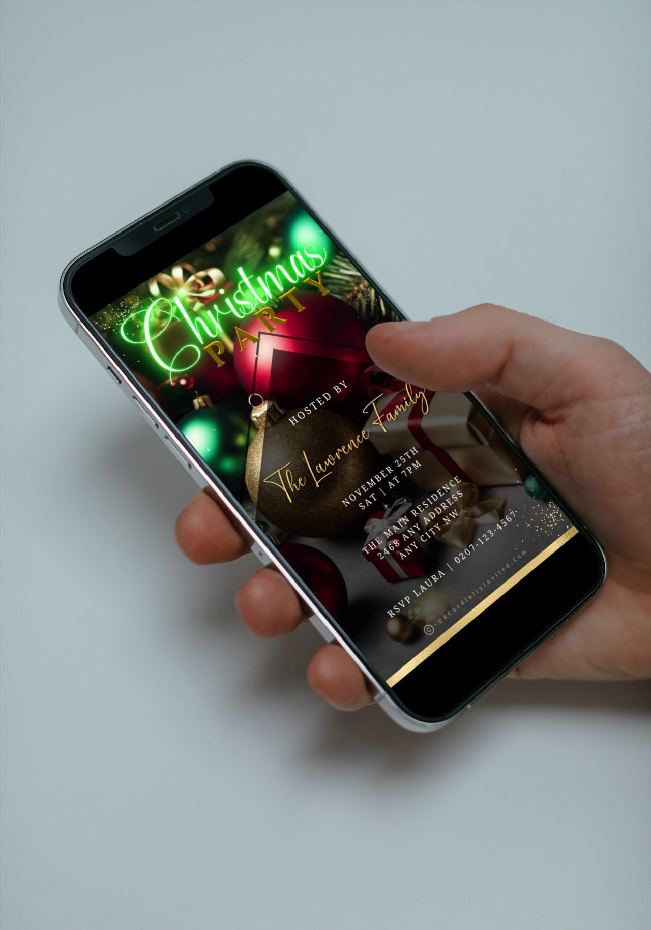 Hand holding a smartphone displaying a Neon Green Presents Ornaments Glitter Christmas Video Invitation for easy DIY customization via Canva.