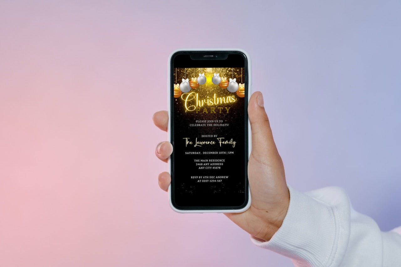 Hand holding a smartphone displaying a customizable Snowy Gold White Ornaments Glitter Christmas Party Video Invite.