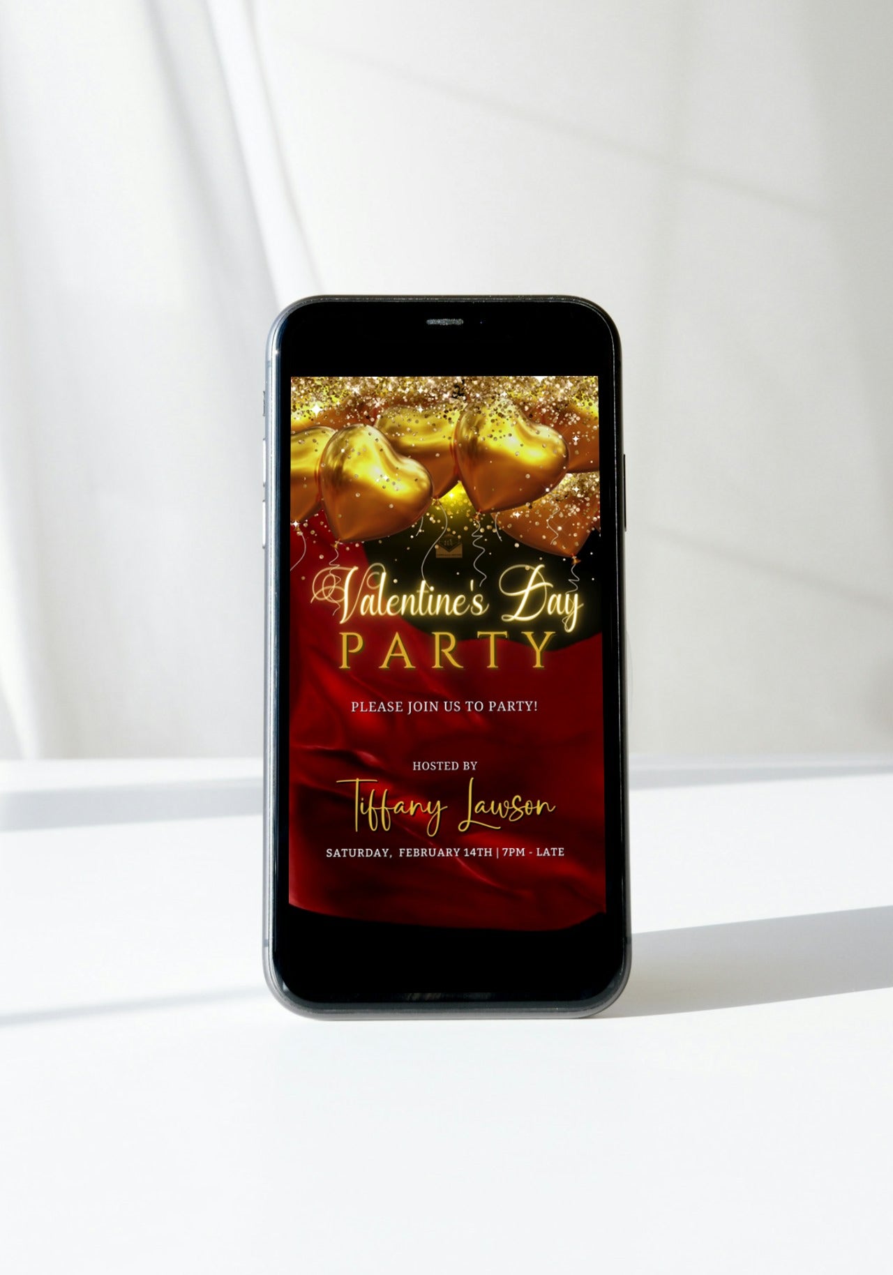 Cell phone displaying editable digital invitation with red silk neon gold heart balloons for Valentine's party.